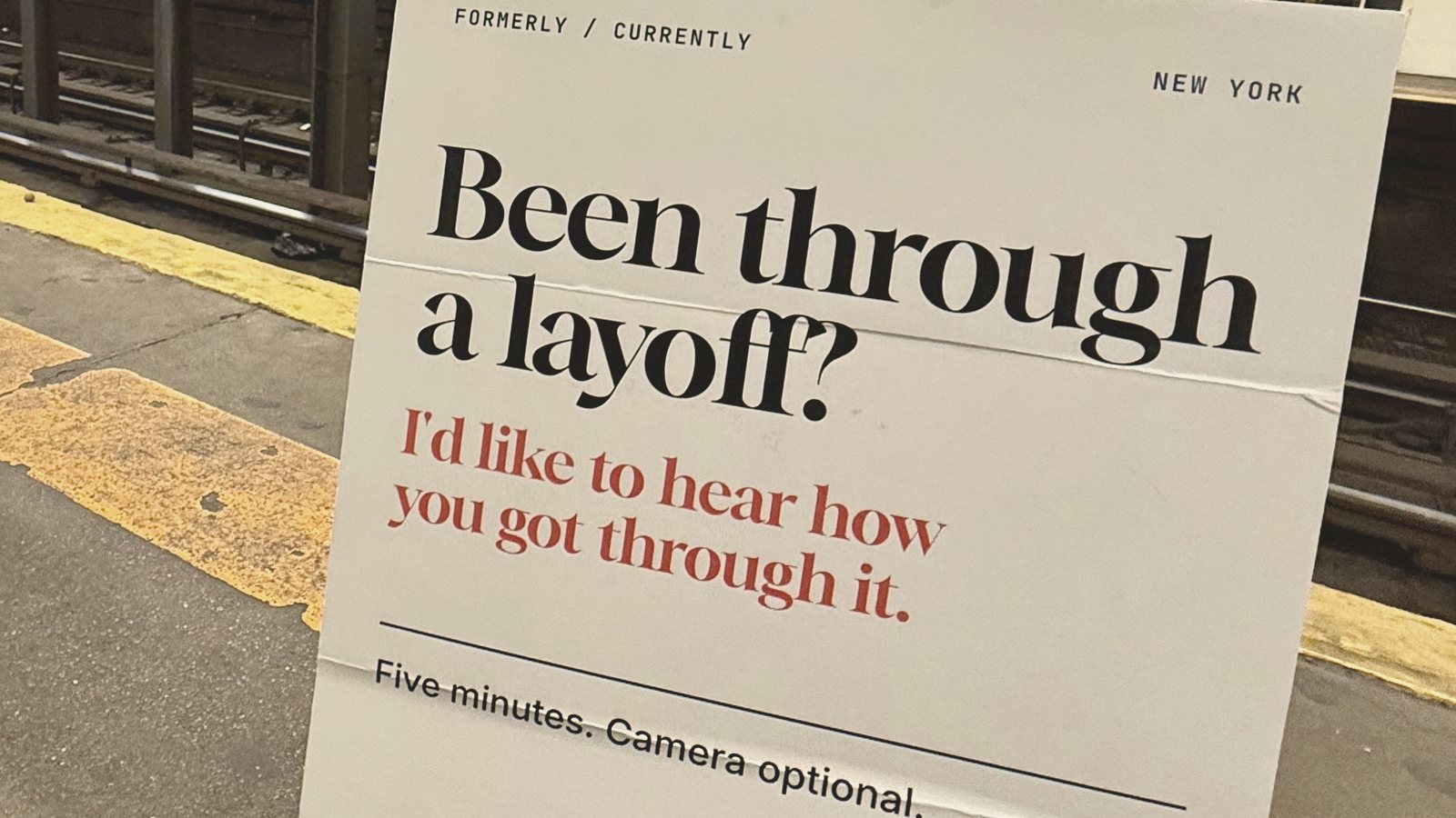 A PinkSlipped sign on a New York subway platform reads: Been through a layoff? I'd like to hear how you got through it.